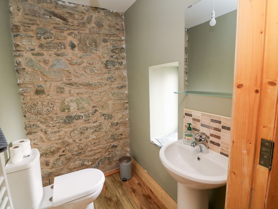 A bathroom with a toilet and sink at The Owl's Hoot in Tacumshane, County Wexford