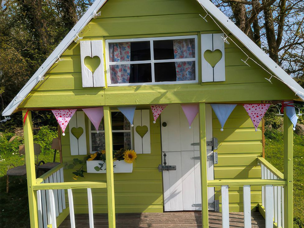 A playhouse with bunting and flowerbox at The Owl's Hoot in Tacumshane, County Wexford