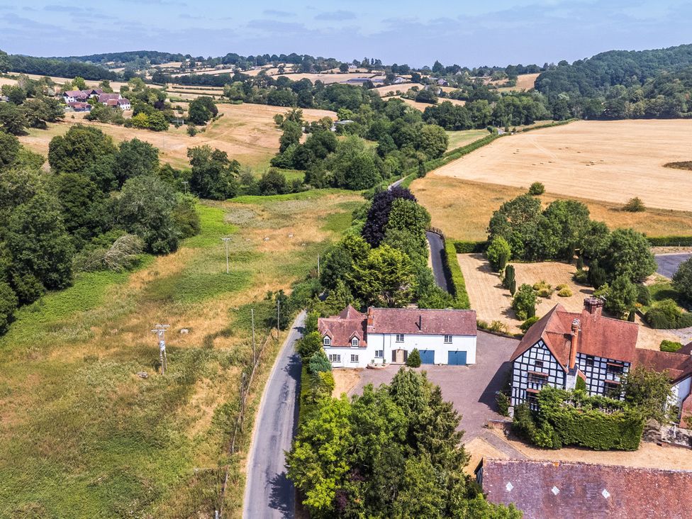 A view of fields and houses from above at Lower Tundridge Cottage Suckley near Malvern