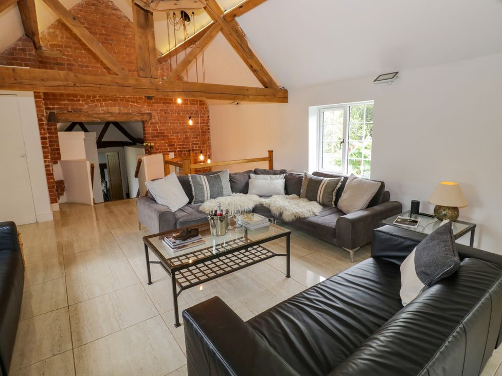A living room with sofas and a table at Lower Tundridge Cottage Suckley near Malvern