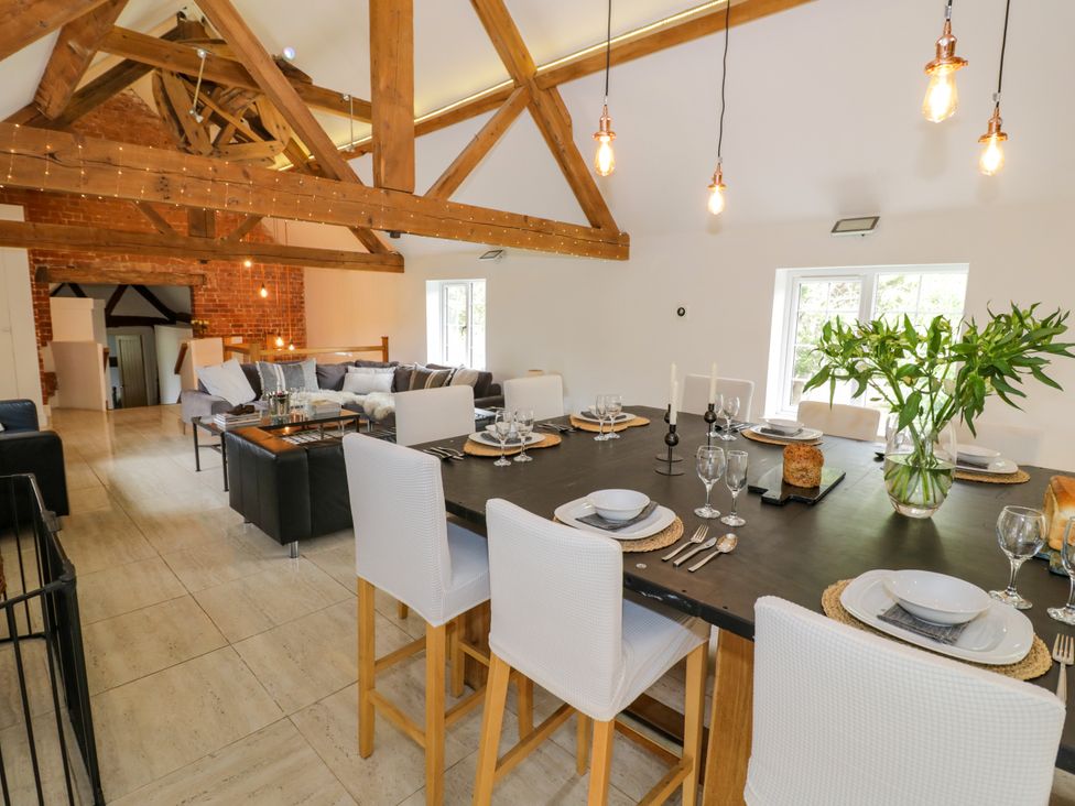 A dining room with a large table set for a meal at Lower Tundridge Cottage Suckley near Malvern