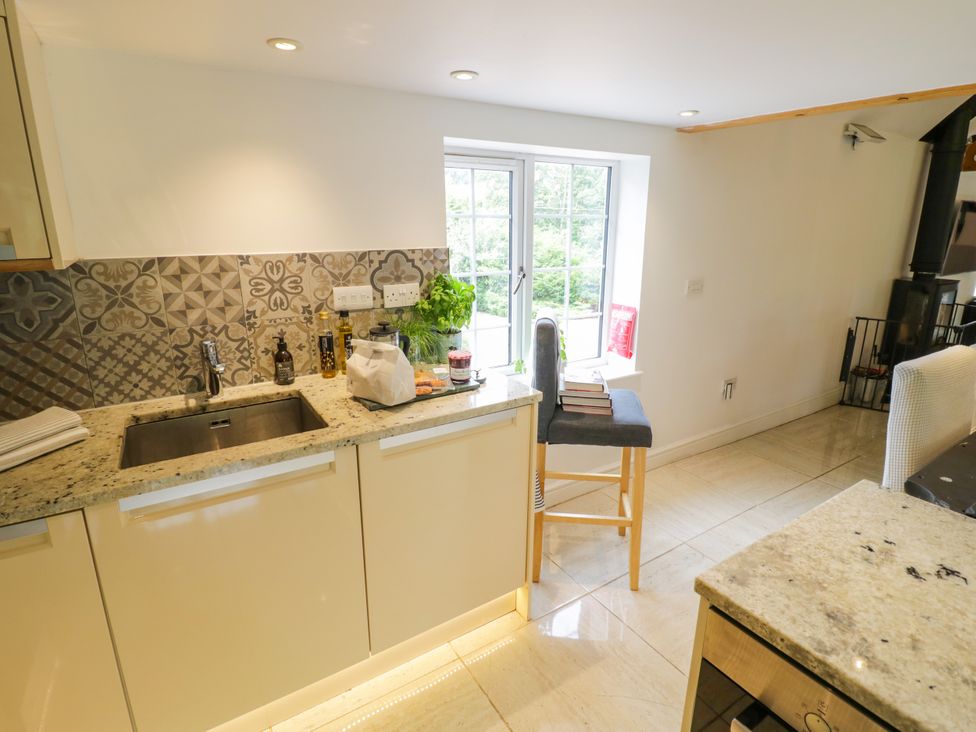 A kitchen with a sink and a window at Lower Tundridge Cottage Suckley near Malvern
