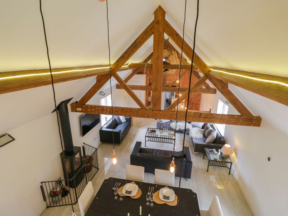 A living room with a dining area and fireplace at Lower Tundridge Cottage Suckley near Malvern