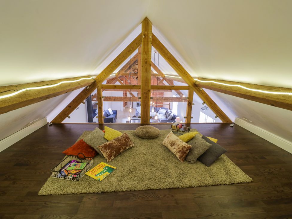 A loft area with cushions and a rug at Lower Tundridge Cottage Suckley near Malvern