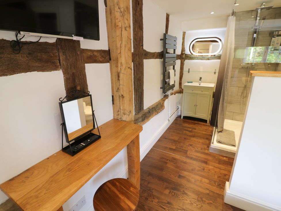 A bathroom with a sink, shower and mirror at Lower Tundridge Cottage Suckley near Malvern