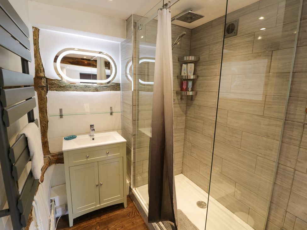 A bathroom with a shower and vanity at Lower Tundridge Cottage Suckley near Malvern