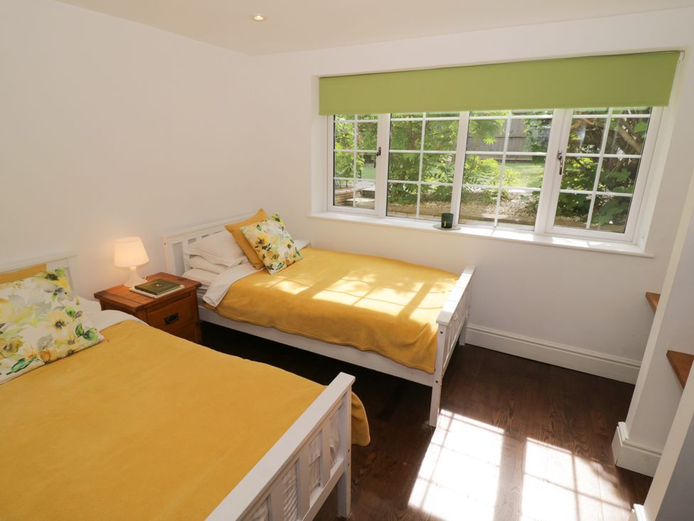 A bedroom with two beds and a window at Lower Tundridge Cottage Suckley near Malvern