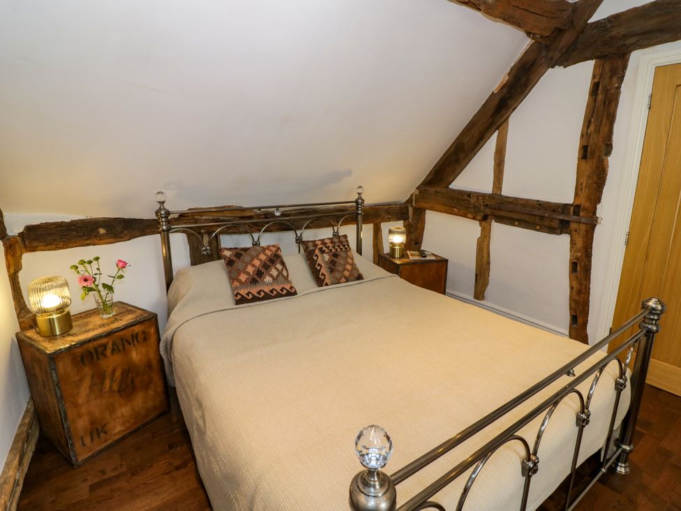 A bedroom with a bed and bedside table at Lower Tundridge Cottage Suckley near Malvern