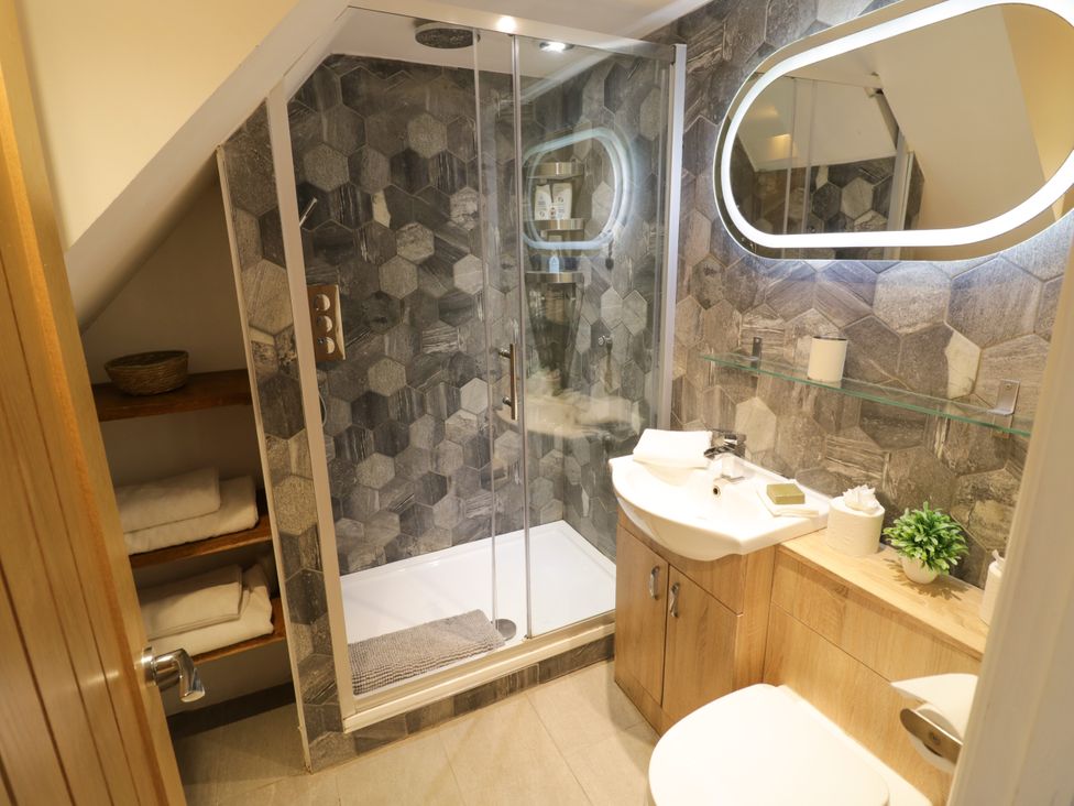 A bathroom featuring a shower, sink, and toilet at Lower Tundridge Cottage Suckley near Malvern