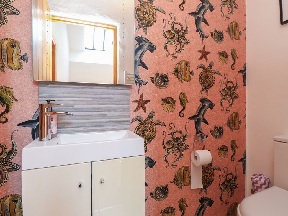 A bathroom with a sink and toilet at Wern Olau Cottage Groeslon near Caernarfon