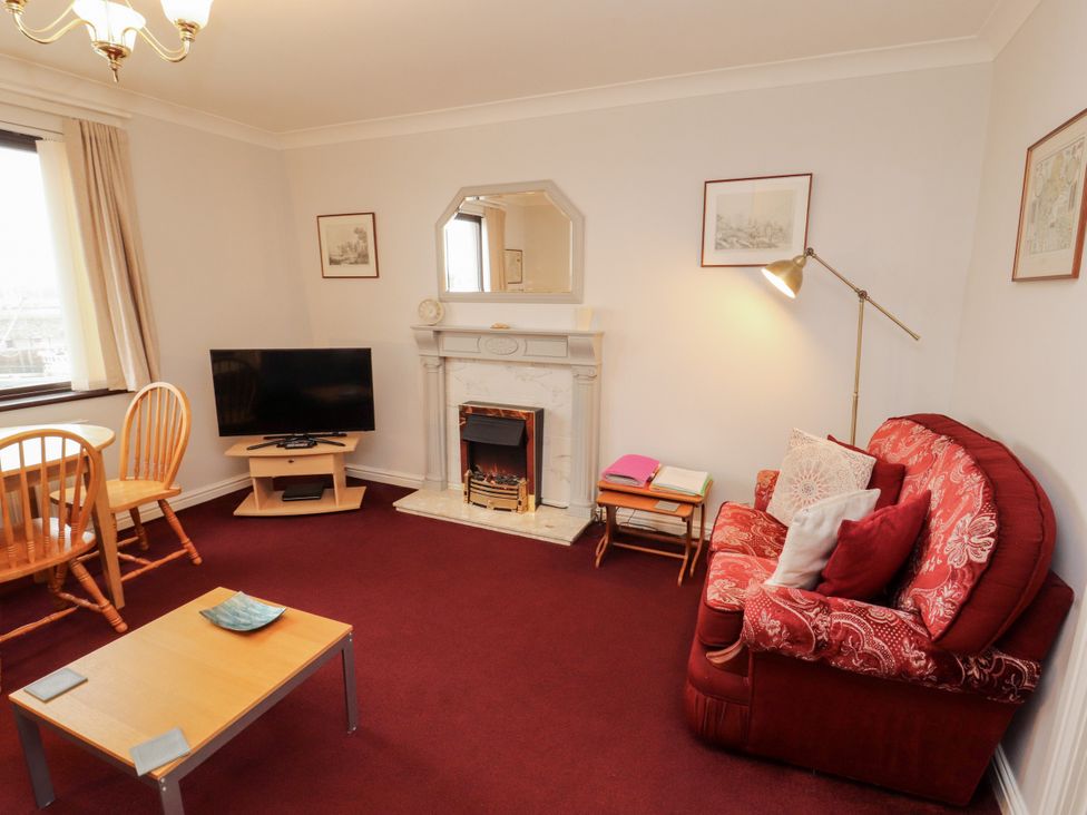 A living room with a television and fireplace at Harbour Side in Maryport