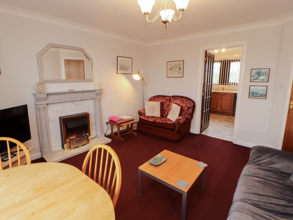 A living room with a sofa and television at Harbour Side in Maryport