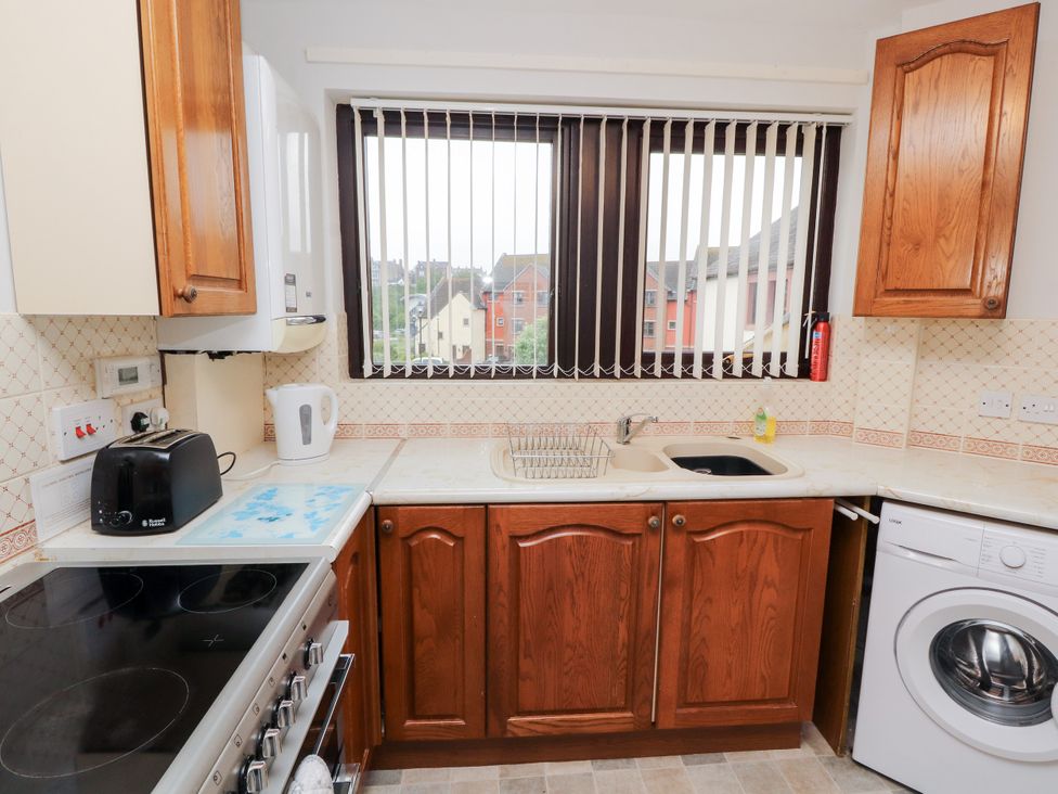 A kitchen with a sink and appliances at Harbour Side in Maryport