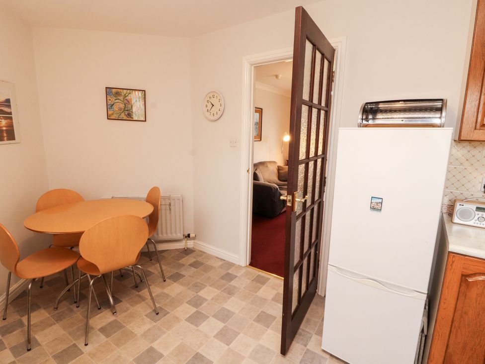 A kitchen with a table and chairs at Harbour Side in Maryport
