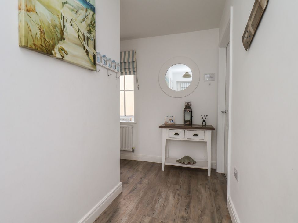 A hallway with a table and a mirror at Coastal Cottage The Bay near Filey