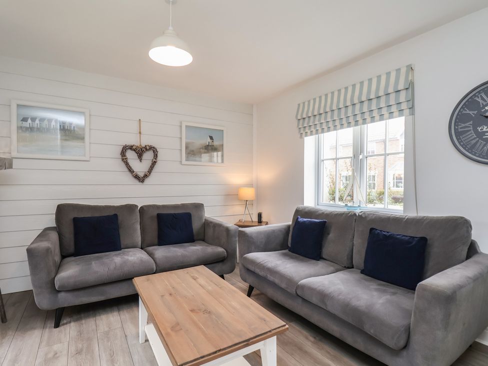A living room with sofas and a coffee table at Coastal Cottage The Bay near Filey