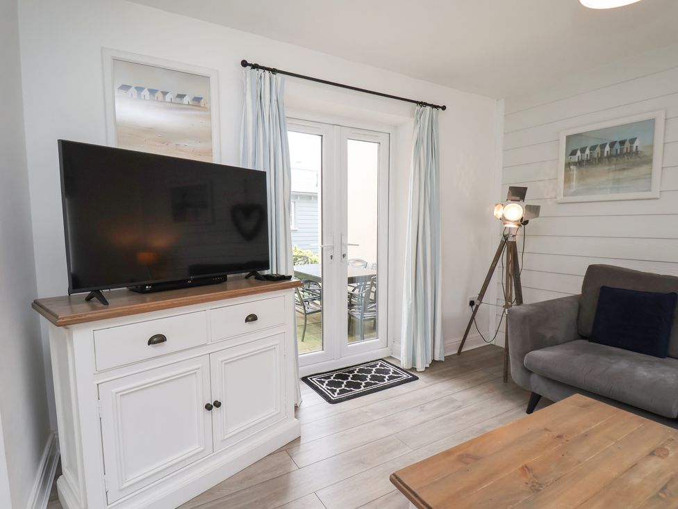 A living room with a television and a sofa at Coastal Cottage The Bay near Filey