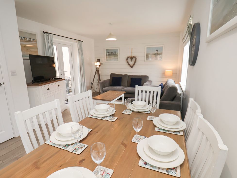 A dining room with a table set for dinner at Coastal Cottage The Bay near Filey
