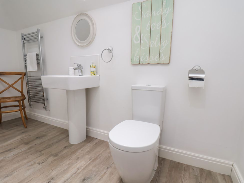 A bathroom with a toilet and sink at Coastal Cottage The Bay near Filey