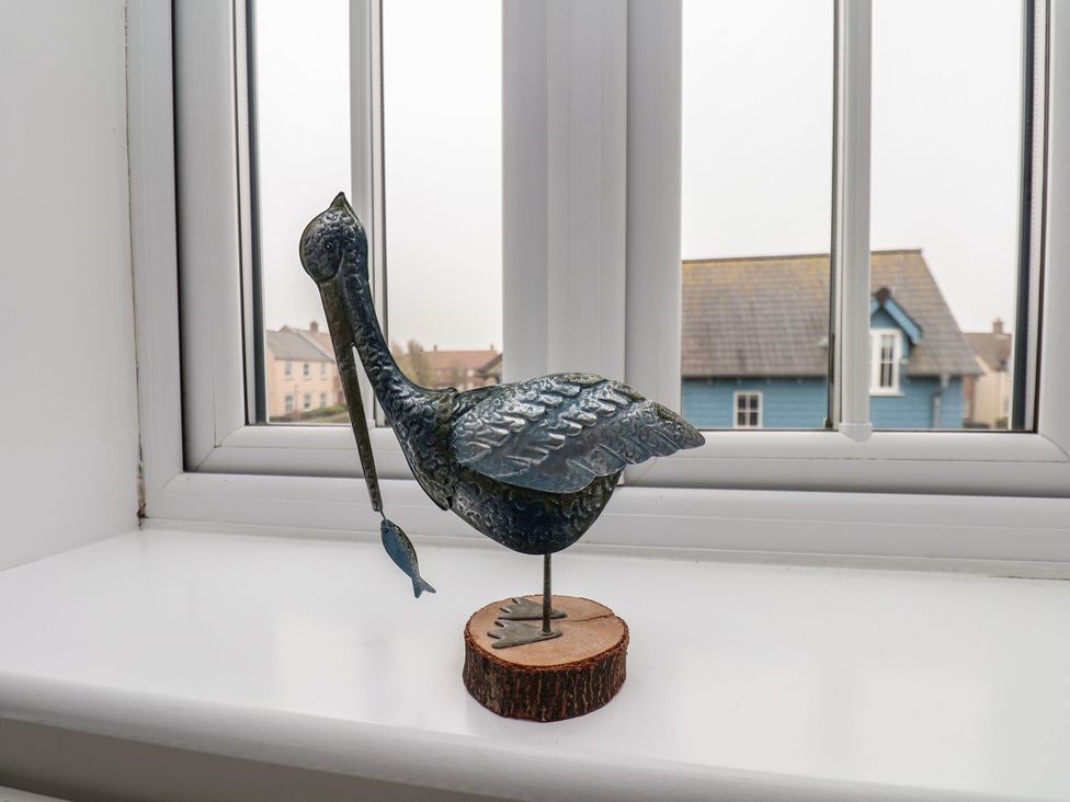 A bird statue on a window sill at Coastal Cottage The Bay near Filey