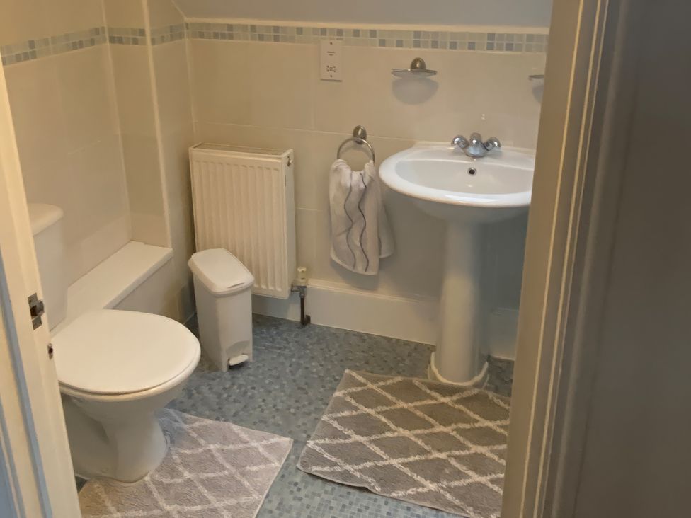 A bathroom with a toilet and sink at The Old Cider Barn in Wookey
