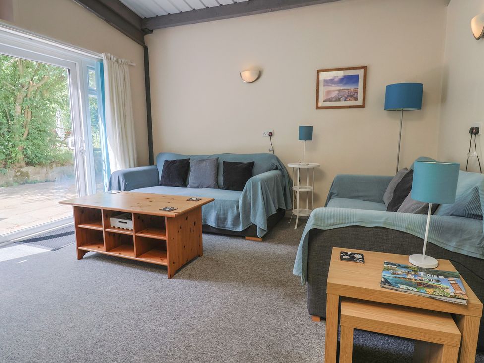A living room with sofas and a coffee table at Brookfield Lodge in Drimpton