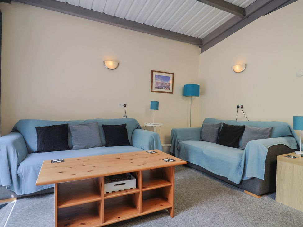 A living room with two sofas and a coffee table at Brookfield Lodge in Drimpton