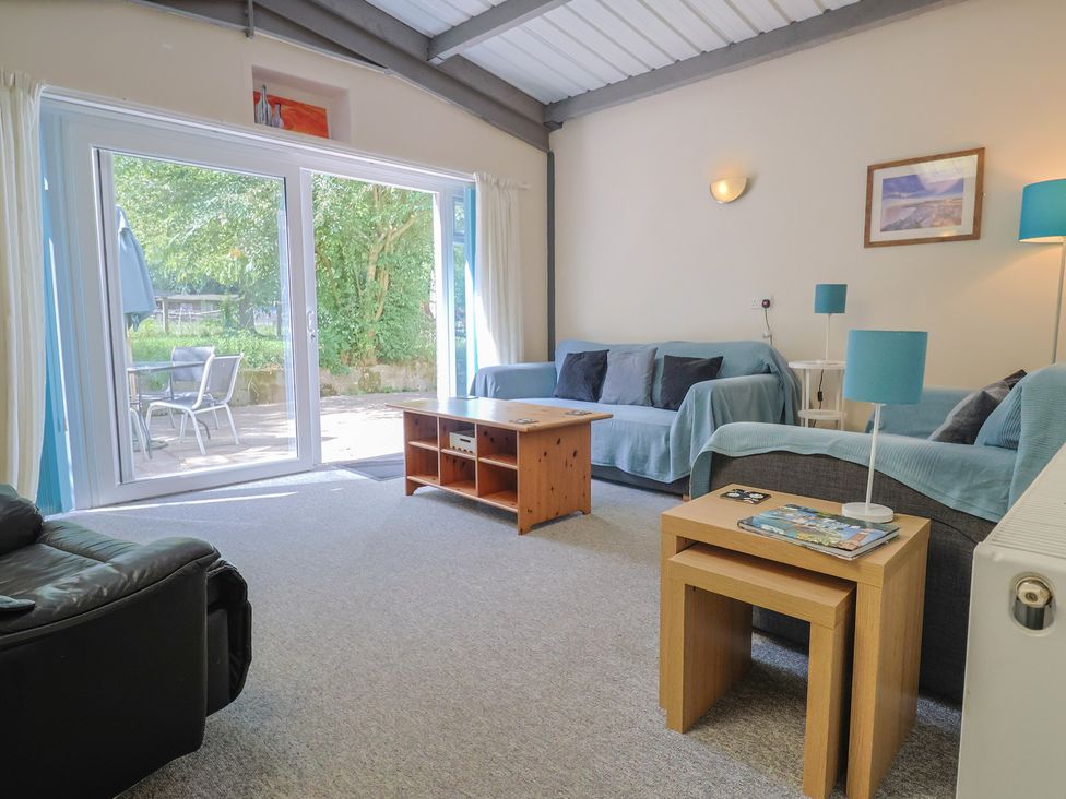 A living room with a sofa and coffee table at Brookfield Lodge in Drimpton