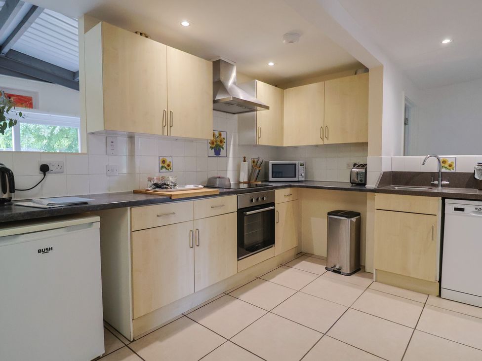 A kitchen with various kitchen appliances and cabinets at Brookfield Lodge in Drimpton