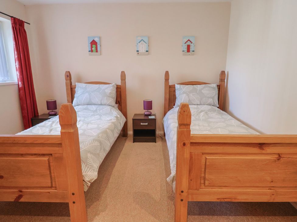 A bedroom with two single beds and side tables at Brookfield Lodge in Drimpton