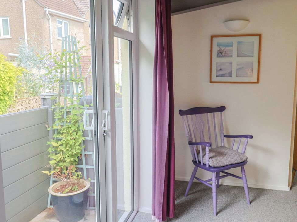A garden room with a purple chair and a plant pot at Brookfield Lodge in Drimpton