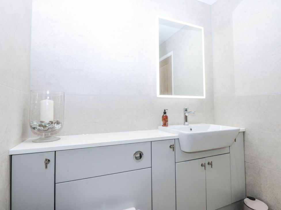 A bathroom with a sink and a mirror at 40 New Row Pwllheli