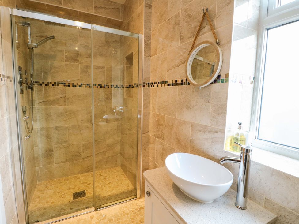 A bathroom with a shower and a sink at Hafod Wen in Pentraeth