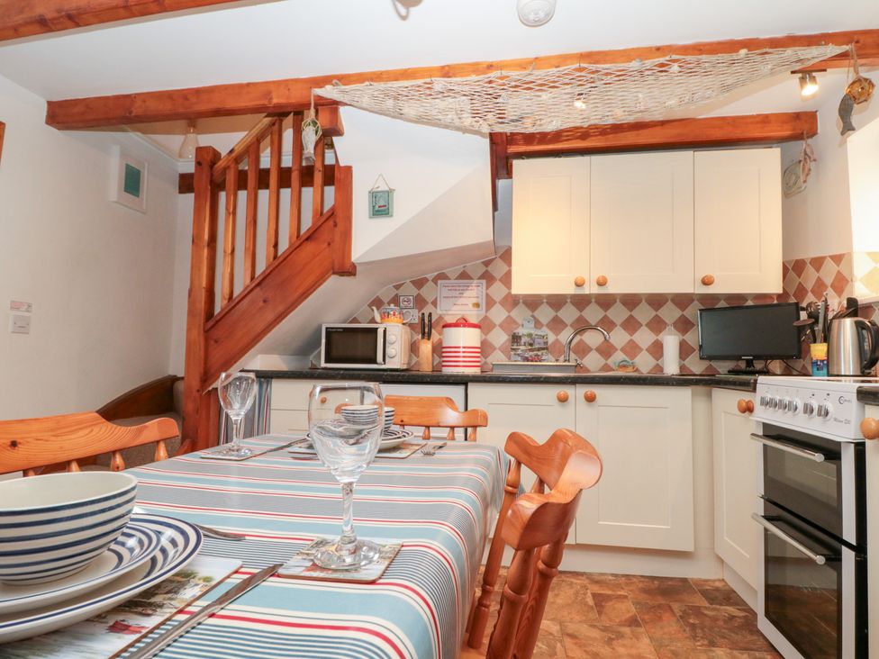 A kitchen with a table and chairs at The Old Cottage in Staithes