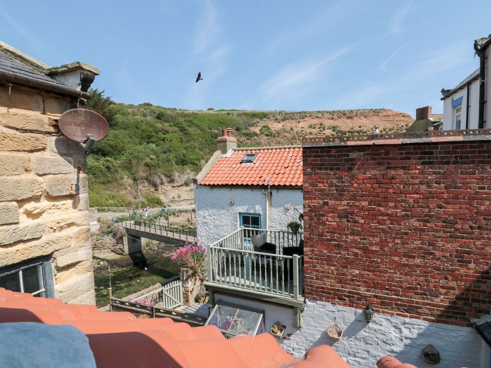 An outdoor view of buildings and a bridge at The Old Cottage in Staithes