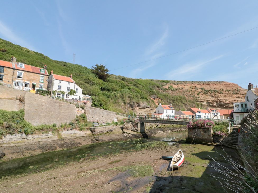 A view of houses and a bridge over a river at The Old Cottage in Staithes