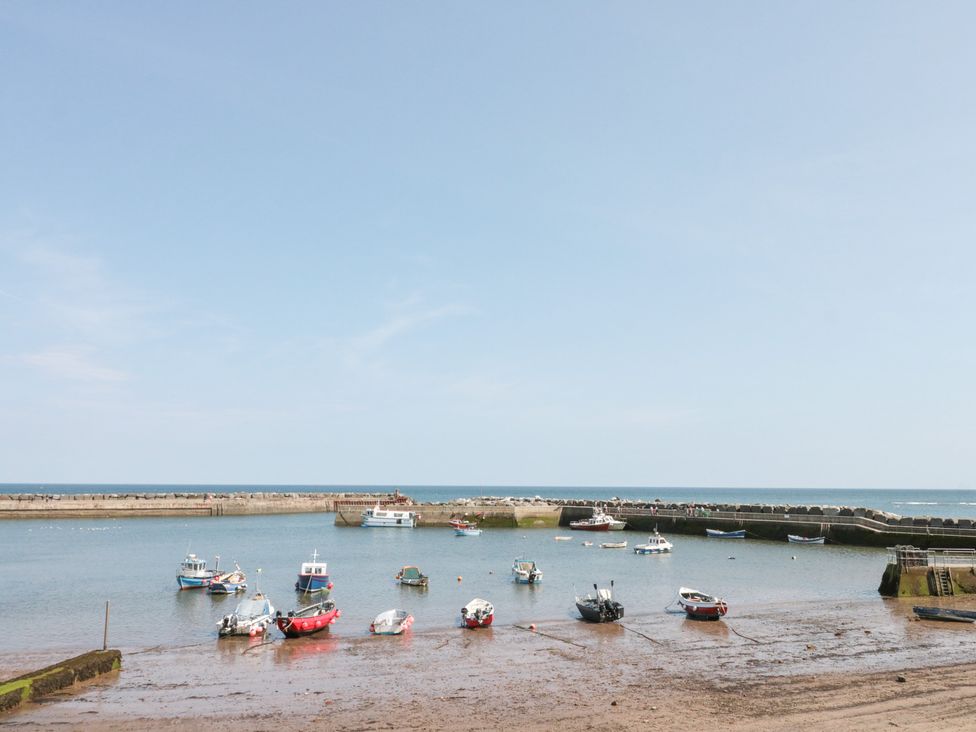 A harbor with boats moored in the water at The Old Cottage in Staithes