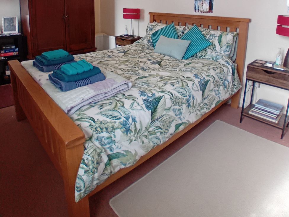 A bedroom with a bed and towels arranged at Emily's Retreat at the Great Barn, Great Dunham, Litcham
