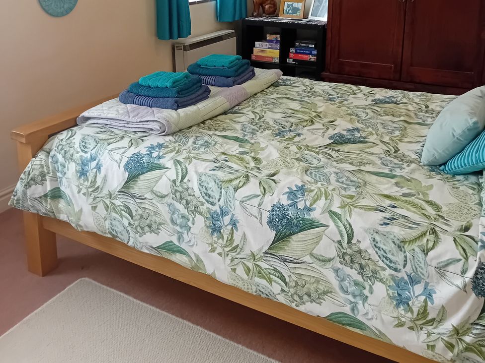 A bedroom with a bed and towels at Emily's Retreat at the Great Barn, Great Dunham, Litcham