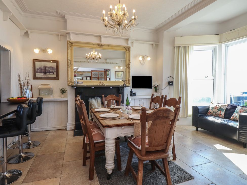 A dining room with a table and chairs at Wavecrest in Pwllheli