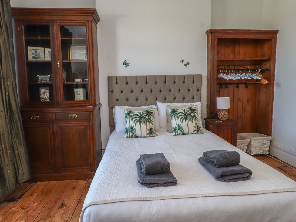 A bedroom with a bed and furniture at Wavecrest in Pwllheli