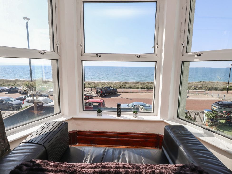 A living room with a view of the sea at Wavecrest in Pwllheli