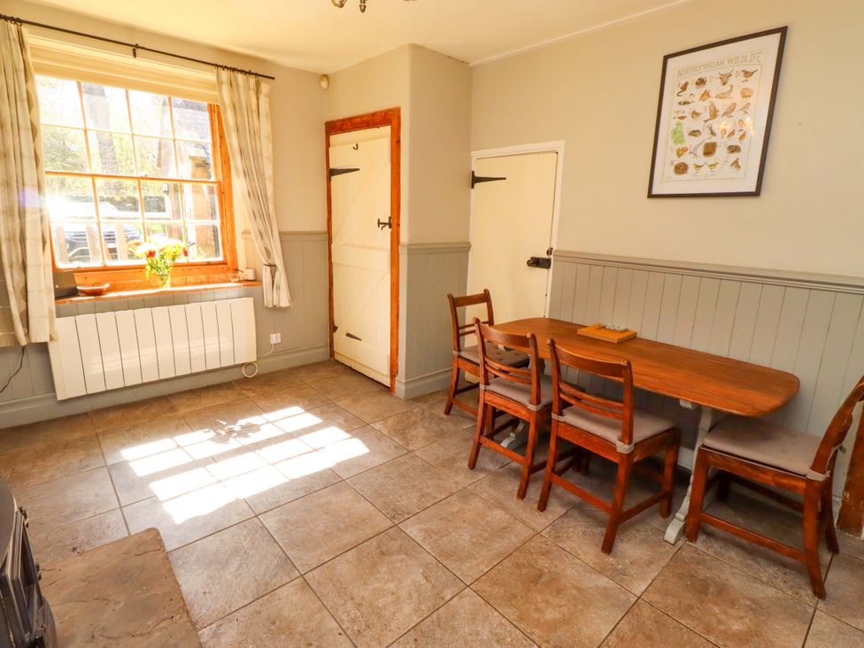 A dining room with a table and chairs at Gamekeepers Cottage in Chillingham near Chatton