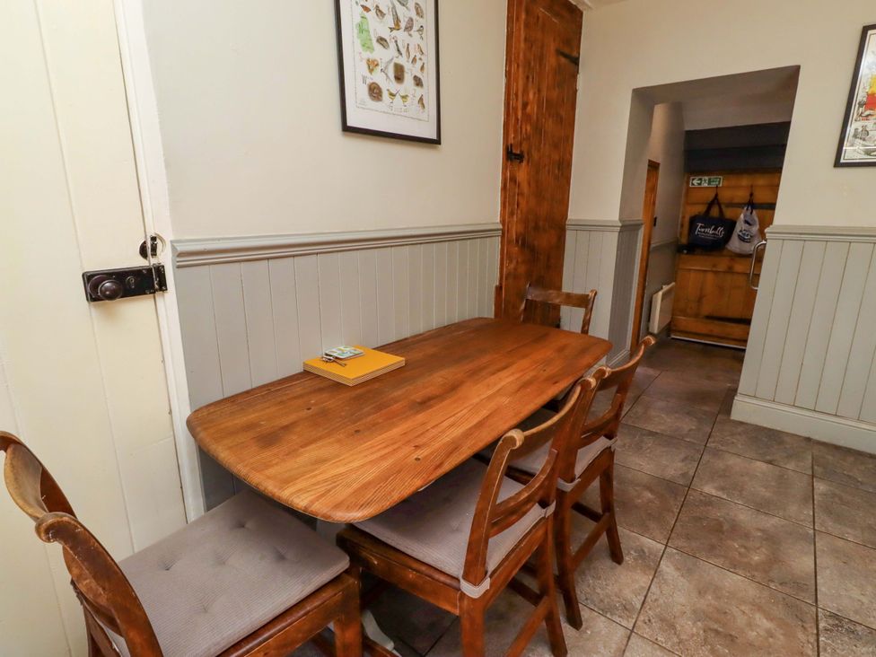 A dining room with a wooden table and chairs at Gamekeepers Cottage in Chillingham near Chatton