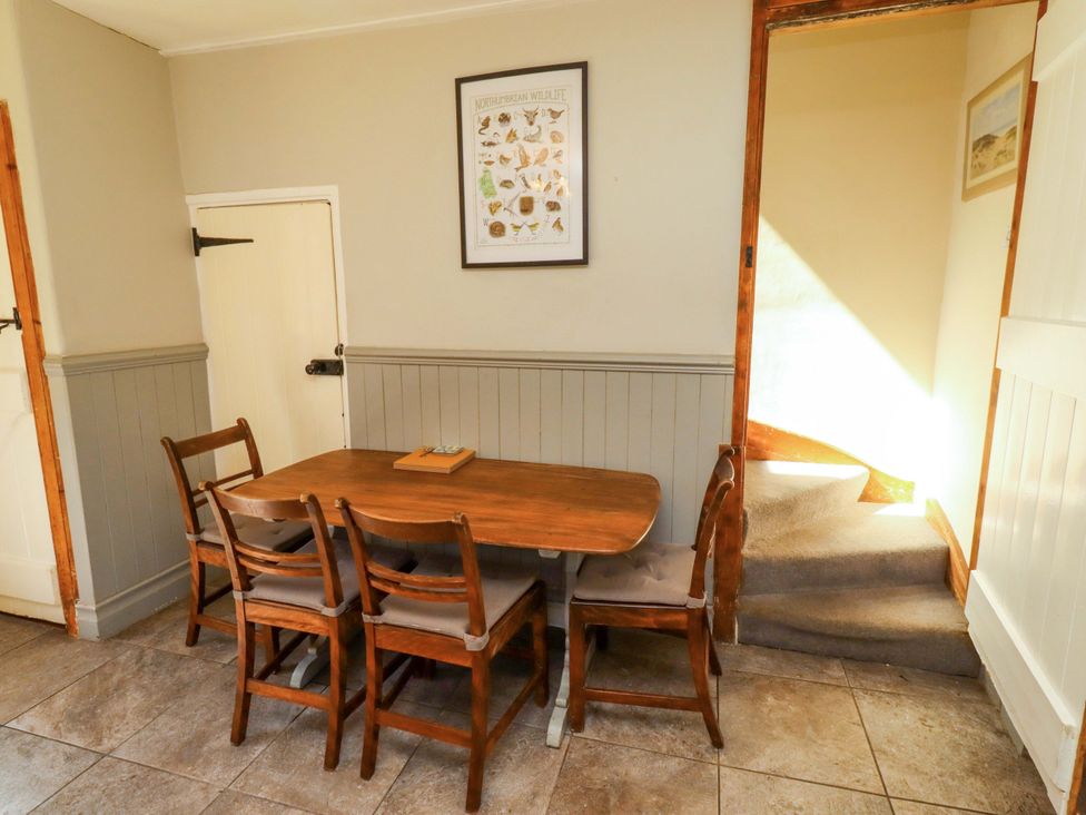A dining room with a table and chairs at Gamekeepers Cottage in Chillingham near Chatton