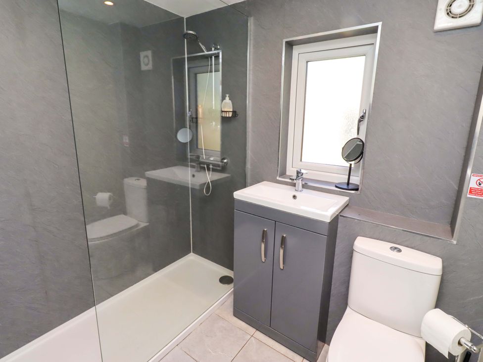 A bathroom with a shower and toilet at Gamekeepers Cottage in Chillingham near Chatton