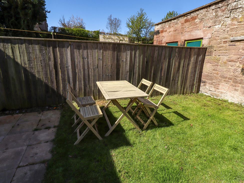 A garden with a table and chairs at Gamekeepers Cottage Chillingham near Chatton