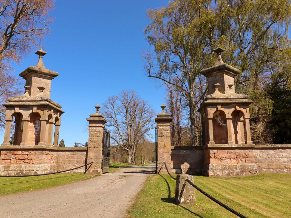 A view of a stone gate with pillars and a pathway at Gamekeepers Cottage in Chillingham near Chatton
