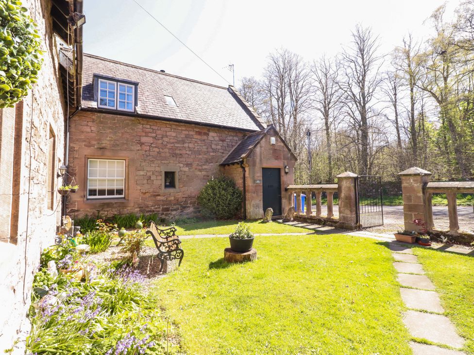An outdoor area with garden and house at Gamekeepers Cottage in Chillingham near Chatton