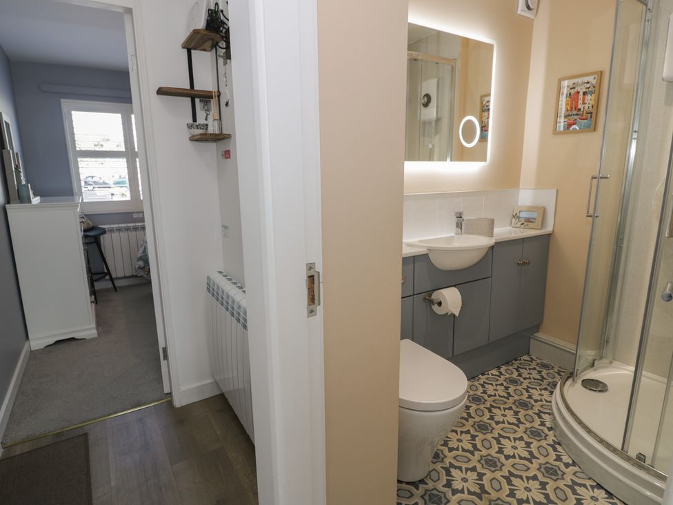 A bathroom with a shower and sink at Lan y Mor in Porthmadog